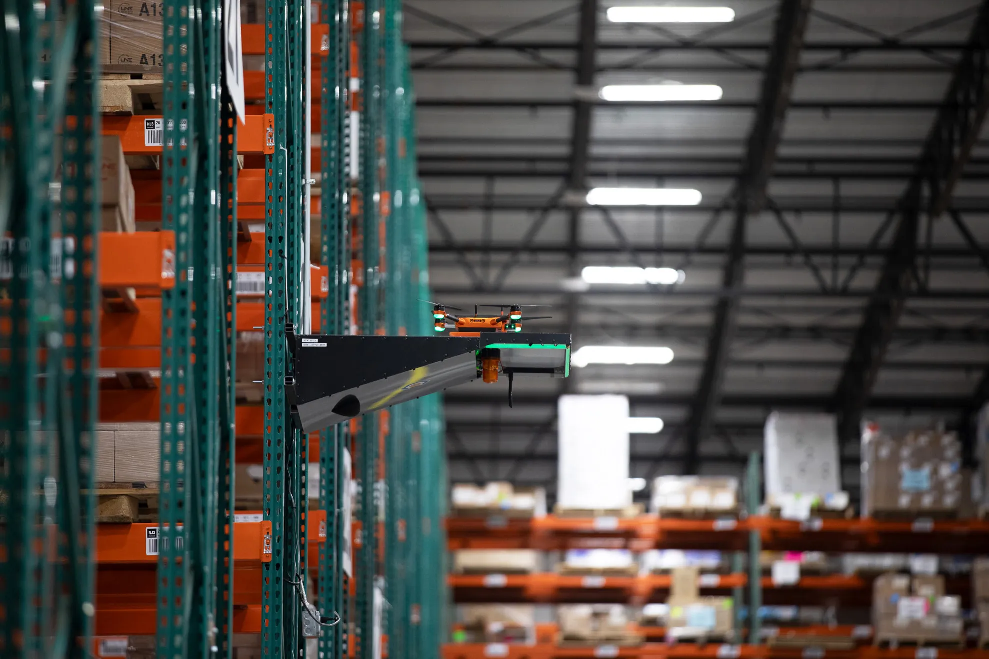 Corvus One drone launching from Corvus Cradle charging station mounted on warehouse rack